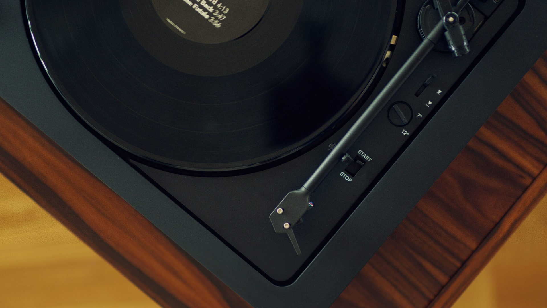 Pro-Ject A2 record player standing on a wooden shelf close up